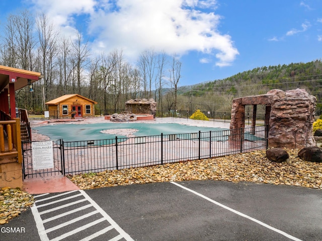 view of swimming pool with a patio area and an outbuilding