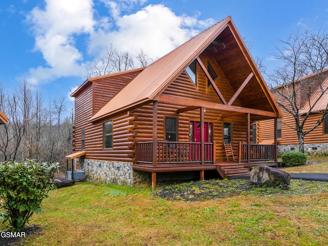 log-style house featuring a porch and a front yard