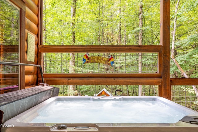 2313 Bogle Spring Loop, Sevierville, TN 37862 - unfurnished sunroom with a jacuzzi and a wooded view
