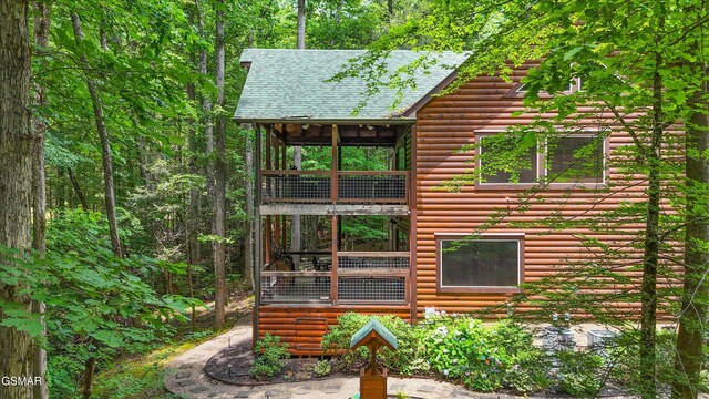 2313 Bogle Spring Loop, Sevierville, TN 37862 - view of home's exterior with a balcony, roof with shingles, and log veneer siding