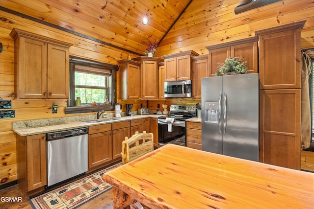 2313 Bogle Spring Loop, Sevierville, TN 37862 - kitchen with stainless steel appliances, vaulted ceiling, brown cabinets, wood walls, and wooden ceiling
