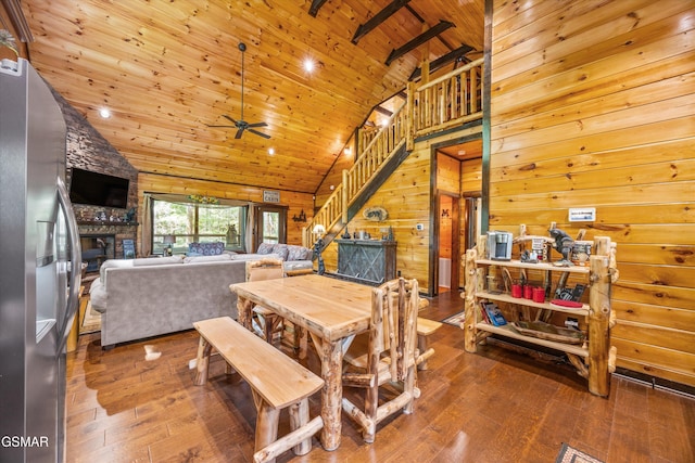 2313 Bogle Spring Loop, Sevierville, TN 37862 - dining area featuring wooden ceiling, hardwood / wood-style flooring, high vaulted ceiling, a fireplace, and stairway