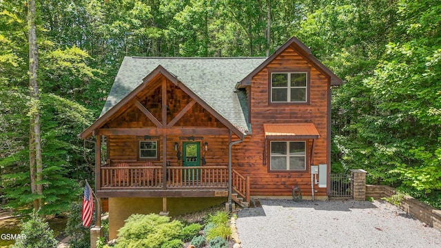 2313 Bogle Spring Loop, Sevierville, TN 37862 - view of front of home with a shingled roof, a porch, and a view of trees