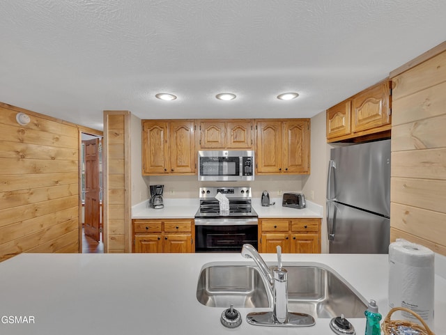 2733 Timber Way, Pigeon Forge, TN 37863 - kitchen featuring appliances with stainless steel finishes, light countertops, a sink, and a textured ceiling