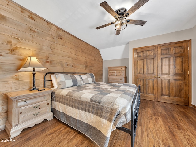 2733 Timber Way, Pigeon Forge, TN 37863 - bedroom featuring wood finished floors, wood walls, lofted ceiling, a closet, and a ceiling fan