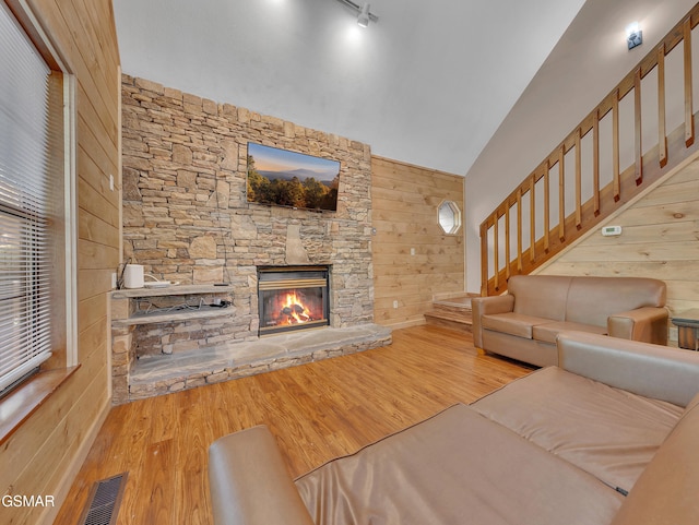 2733 Timber Way, Pigeon Forge, TN 37863 - living area with a fireplace, wood finished floors, rail lighting, stairs, and wood walls