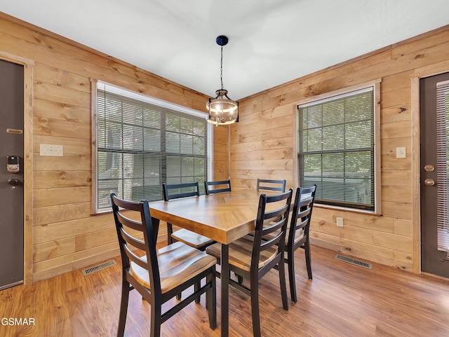 2733 Timber Way, Pigeon Forge, TN 37863 - dining space featuring wood walls and light wood-style floors