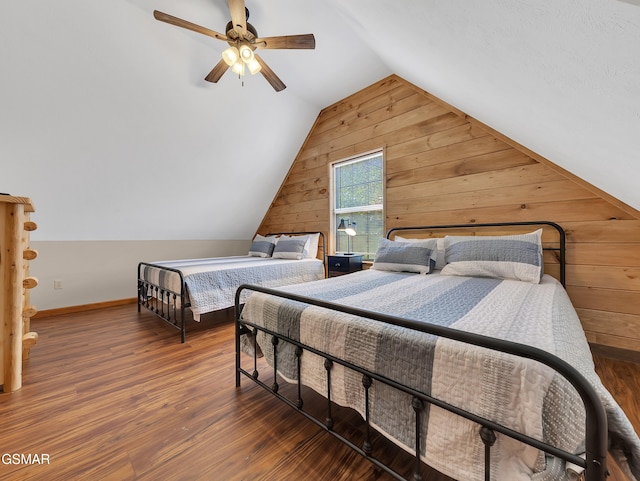 2733 Timber Way, Pigeon Forge, TN 37863 - bedroom featuring wooden walls, lofted ceiling, wood finished floors, a ceiling fan, and baseboards