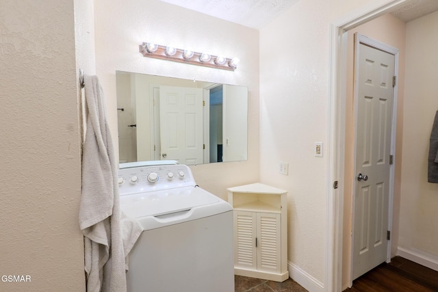 clothes washing area featuring laundry area, baseboards, a textured wall, dark wood-type flooring, and washer / dryer