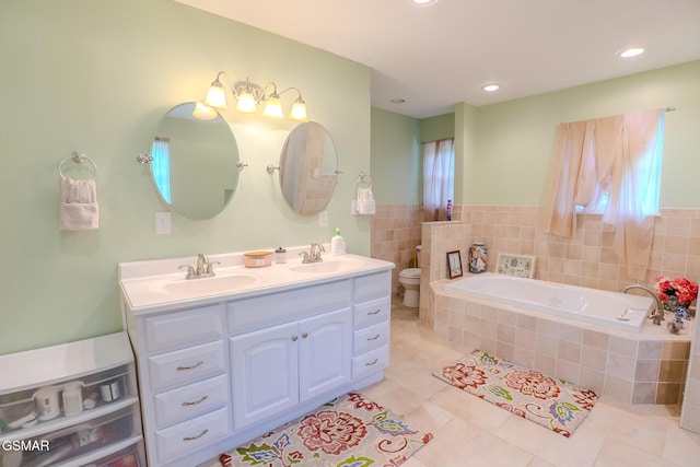 bathroom featuring double vanity, a garden tub, tile patterned flooring, and a sink