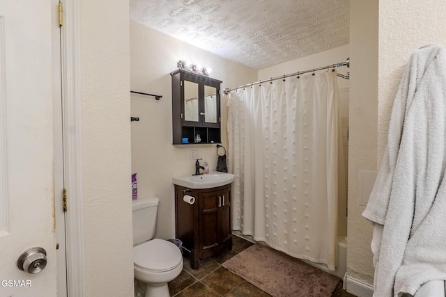 bathroom with tile patterned flooring, a textured ceiling, toilet, and vanity