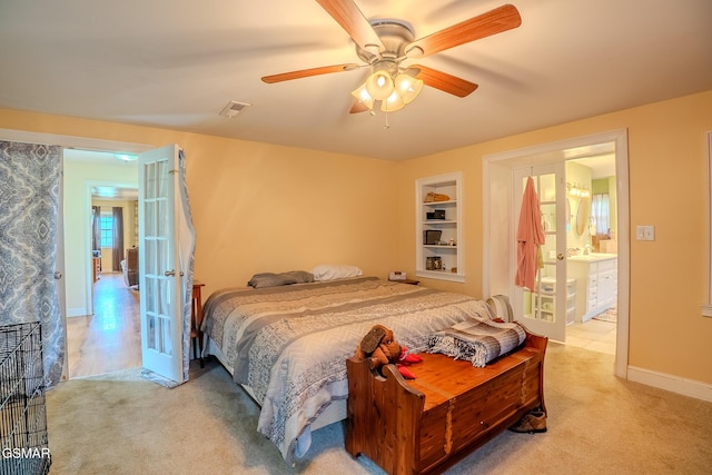 carpeted bedroom featuring visible vents, a ceiling fan, french doors, ensuite bath, and baseboards
