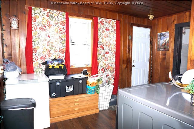 interior space with gray cabinetry, dark hardwood / wood-style flooring, and wooden walls