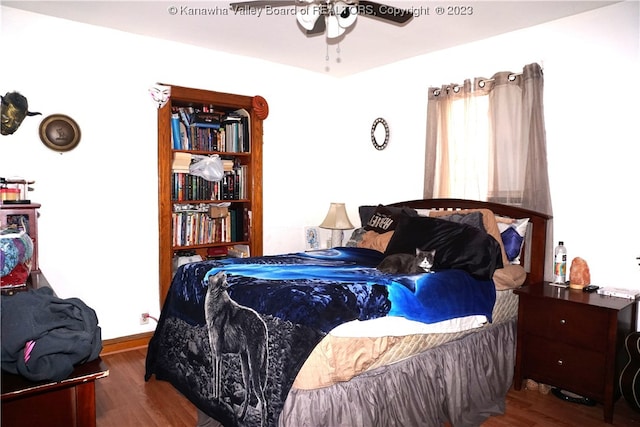 bedroom with ceiling fan and dark hardwood / wood-style flooring