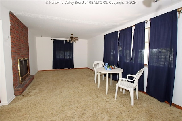 carpeted dining area featuring a brick fireplace