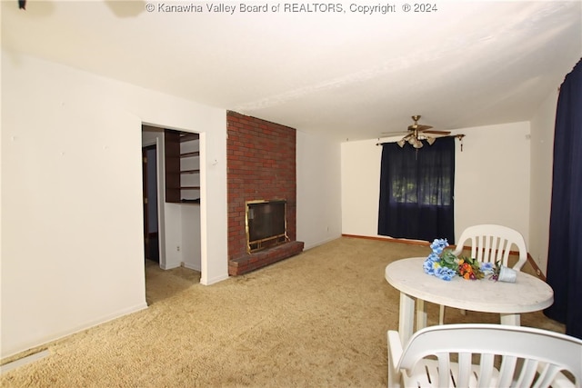 unfurnished living room with a fireplace, light carpet, and ceiling fan