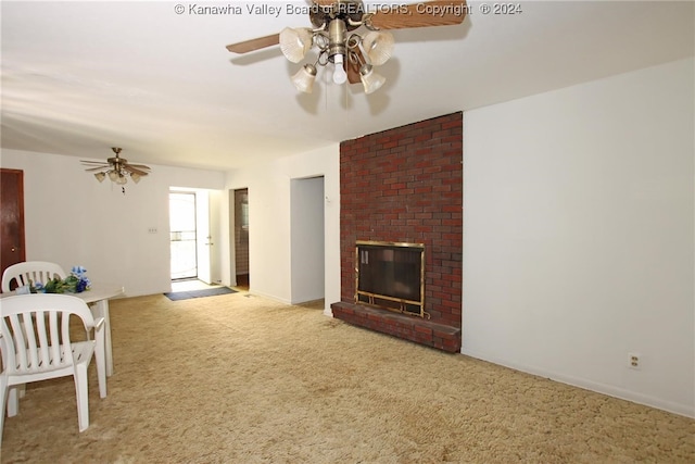 living room with ceiling fan, light colored carpet, and a fireplace