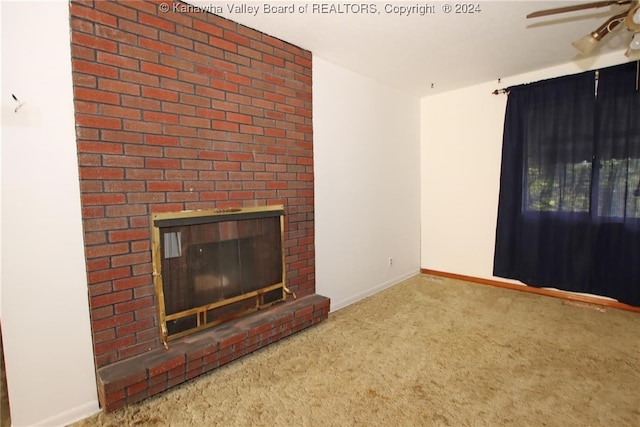 unfurnished living room featuring light carpet, a brick fireplace, and ceiling fan