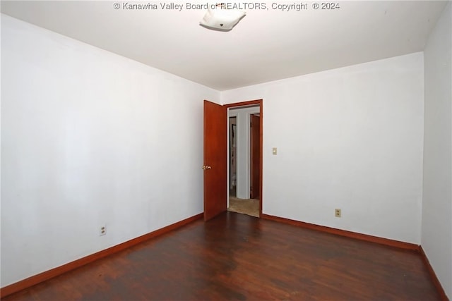 unfurnished room with dark hardwood / wood-style floors