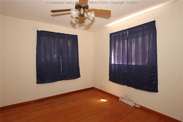 unfurnished room with ceiling fan and wood-type flooring