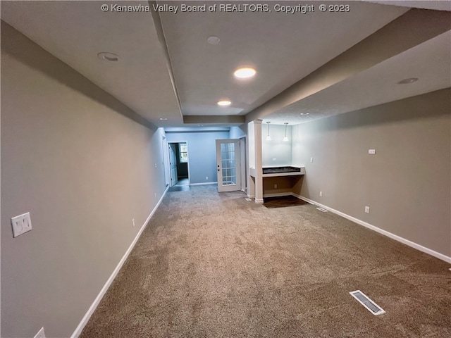 basement featuring light carpet