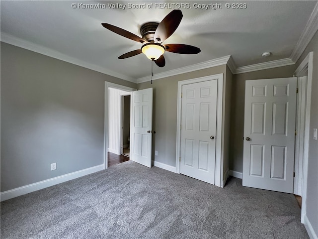 unfurnished bedroom with ceiling fan, crown molding, and dark colored carpet