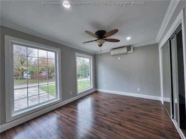 spare room with crown molding, dark hardwood / wood-style floors, ceiling fan, and a wall unit AC