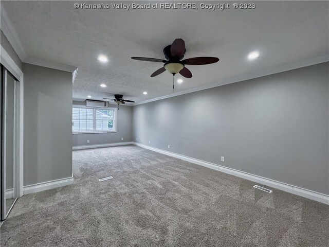 carpeted spare room with ornamental molding, ceiling fan, and a textured ceiling