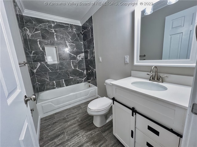 full bathroom with toilet, ornamental molding, tiled shower / bath combo, and vanity