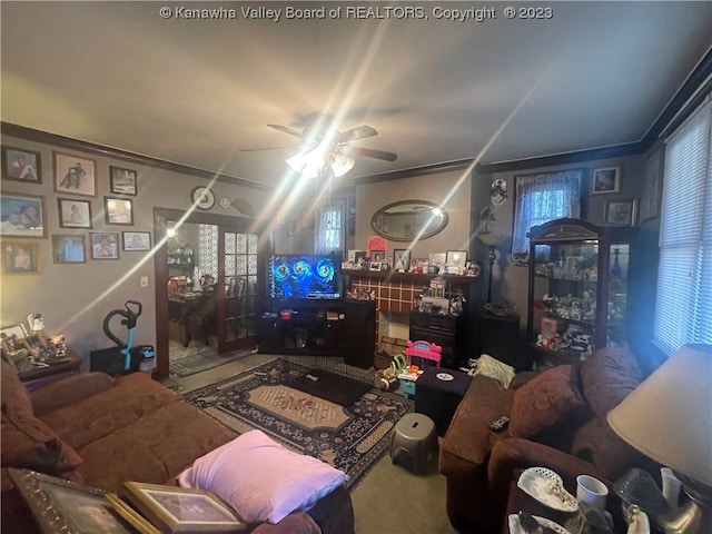 carpeted living room featuring ceiling fan