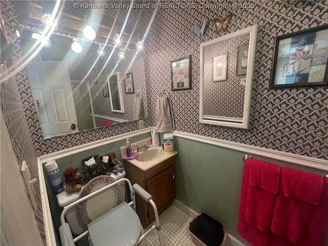 bathroom featuring tile floors, toilet, and vanity