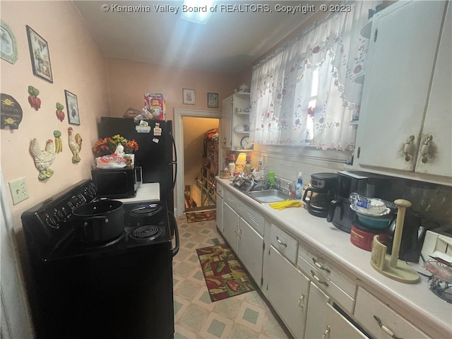 kitchen with black appliances, sink, and light tile floors