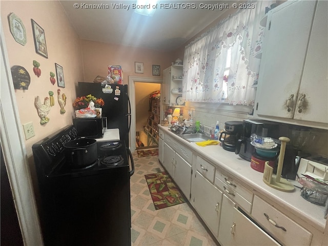 kitchen featuring light tile floors, black appliances, and sink