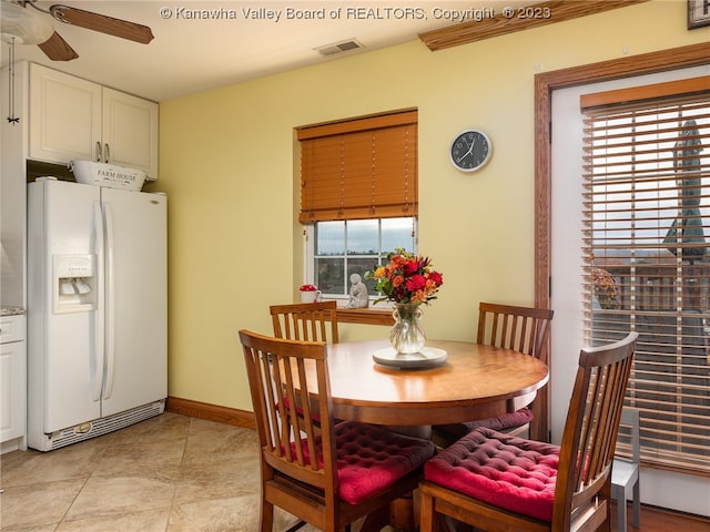 dining space with light tile flooring and ceiling fan