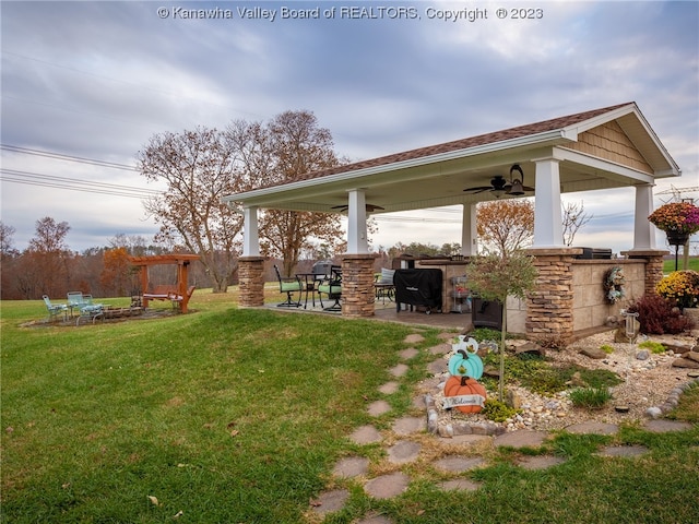 view of yard with a patio, an outdoor bar, and ceiling fan