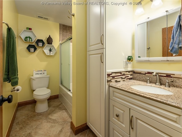 full bathroom with tile flooring, oversized vanity, tasteful backsplash, combined bath / shower with glass door, and toilet