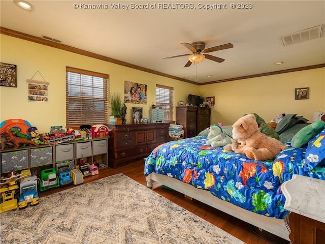 bedroom featuring dark hardwood / wood-style floors, ceiling fan, and crown molding