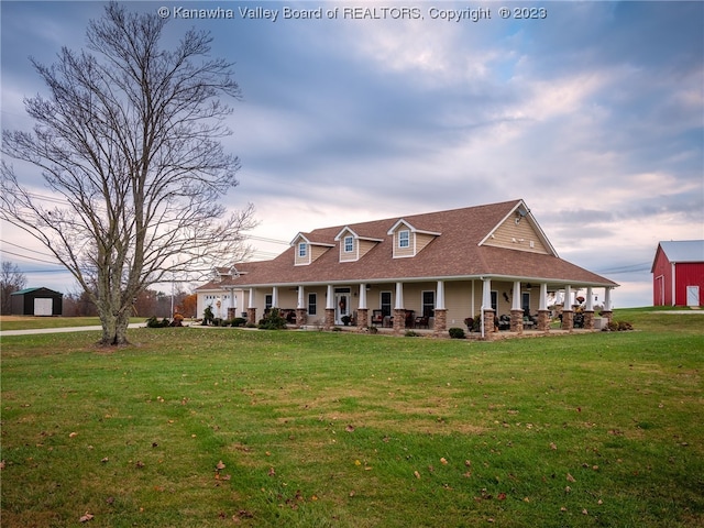 view of front facade with covered porch and a lawn