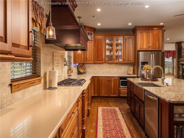 kitchen with dark wood-type flooring, backsplash, pendant lighting, and appliances with stainless steel finishes