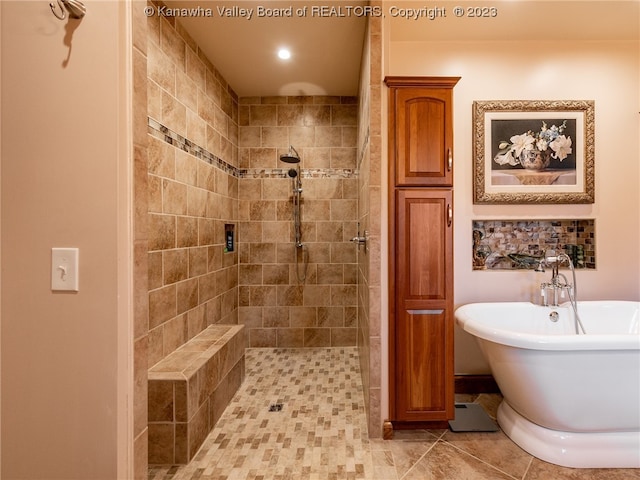 bathroom featuring tile flooring and separate shower and tub