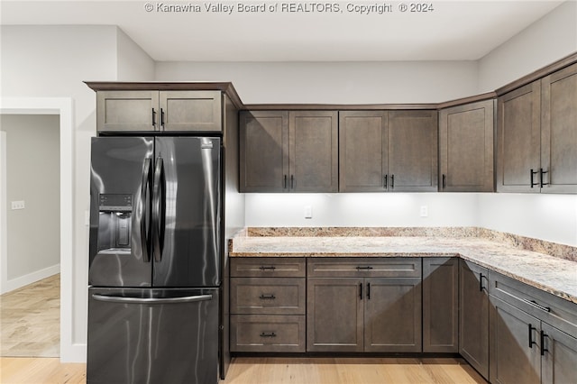 233 Woodland Dr, Milton, WV 25541 - kitchen featuring stainless steel fridge, dark brown cabinetry, and light stone countertops