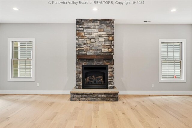 227 Woodland Dr, Milton, WV 25541 - unfurnished living room featuring wood finished floors, a stone fireplace, baseboards, and recessed lighting