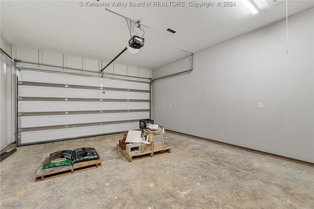 227 Woodland Dr, Milton, WV 25541 - garage featuring a garage door opener