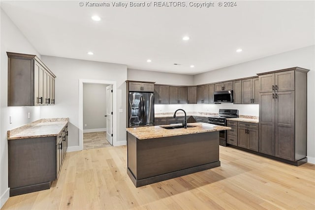 227 Woodland Dr, Milton, WV 25541 - kitchen with stainless steel appliances, a sink, dark brown cabinets, light stone counters, and baseboards