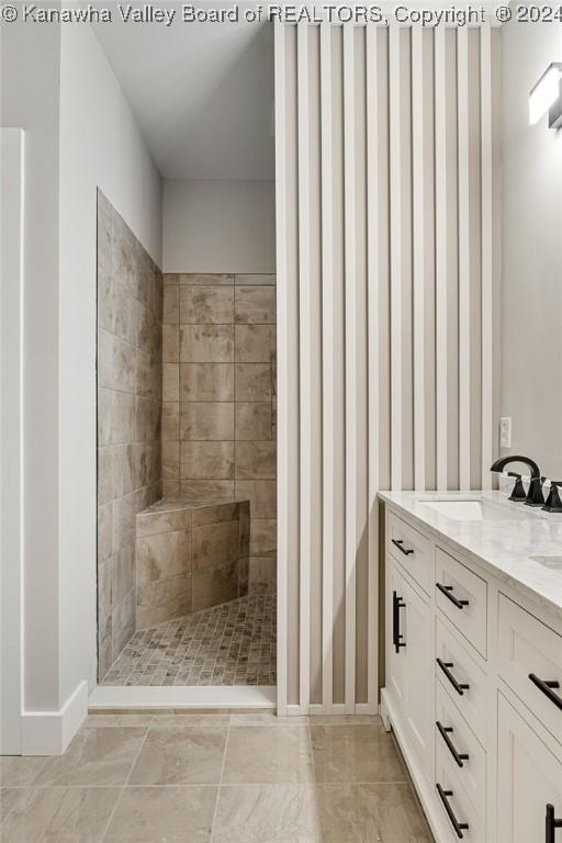 227 Woodland Dr, Milton, WV 25541 - full bathroom with a tile shower, double vanity, and baseboards