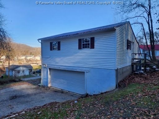 view of side of home featuring a garage