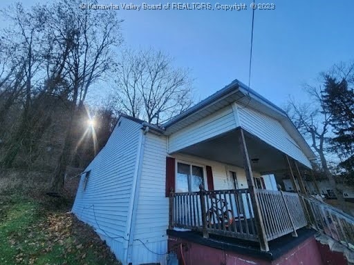 view of side of property featuring a porch