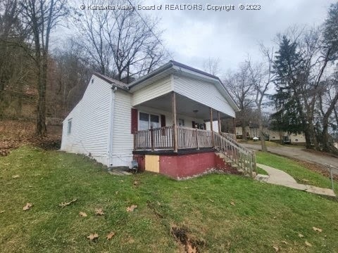 exterior space with a porch and a front lawn