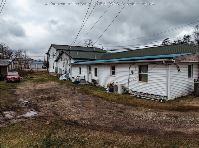 rear view of property featuring central AC