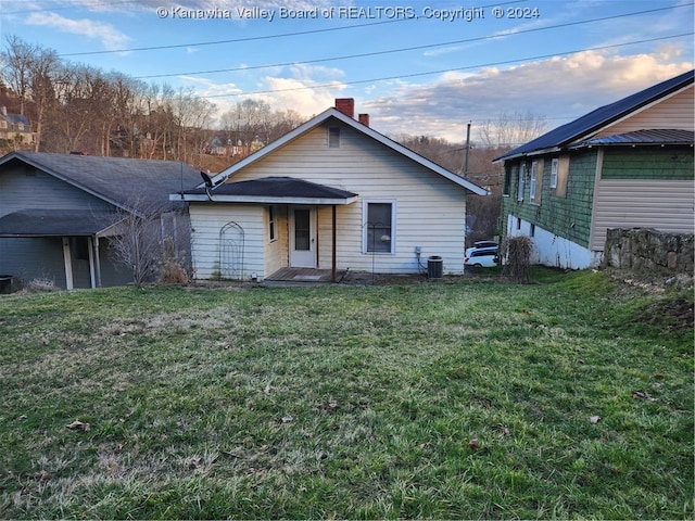 rear view of house featuring a yard